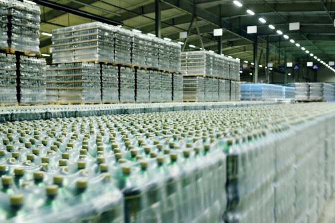 Food industrial warehouse for storage and storage of tetrapacks with drinks, water, beer in plastic PET bottles.